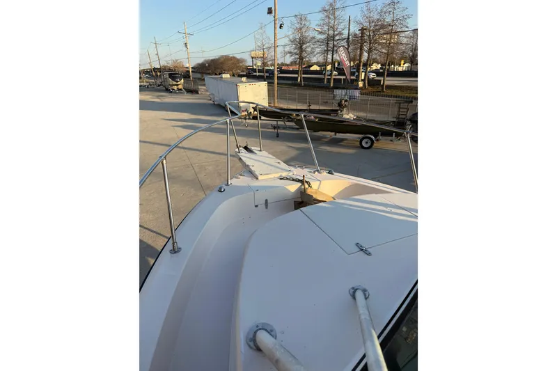 Slide: The Image of 1992 Grady White 300 Marlin boat docked, showcasing bow and railings. - 11