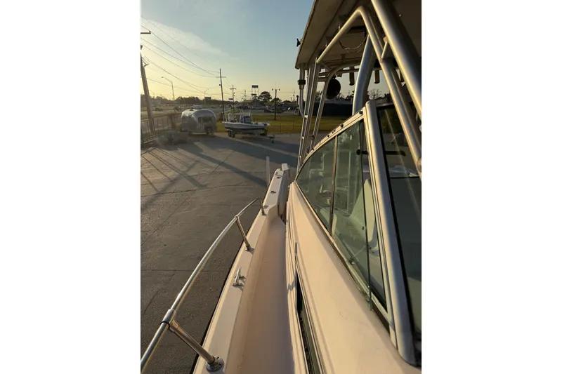 Slide: The Image of 1992 Grady White 300 Marlin boat docked, side view at sunset. - 13