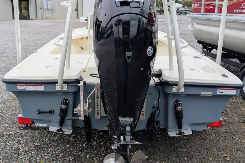 Slide: The Image of 2023 Mako 18 LTS boat rear view with outboard motor and ladder. - 3