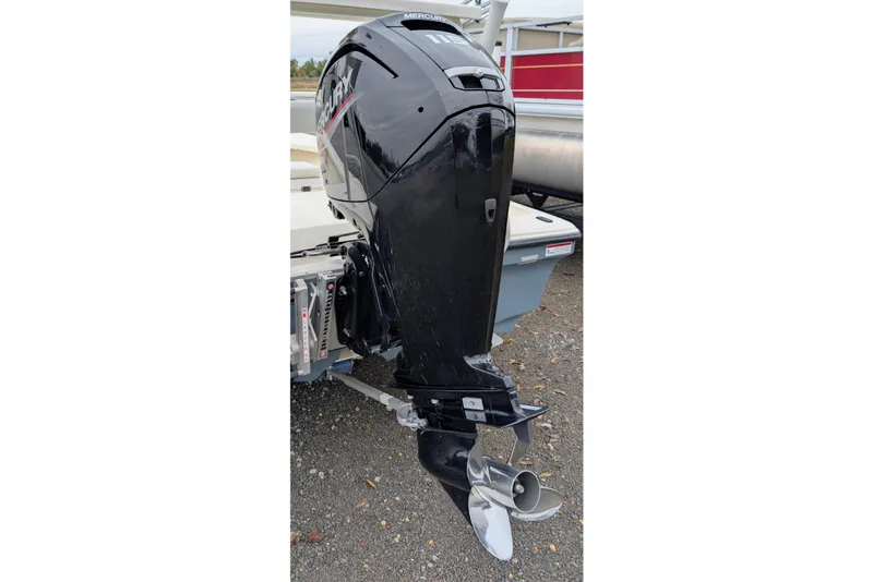 Slide: The Image of 2023 Mako 18 LTS boat with a Mercury outboard motor, parked on gravel. - 4