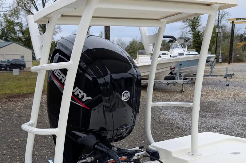 Slide: The Image of 2023 Mako 18 LTS boat with Mercury outboard motor, parked outdoors. - 5