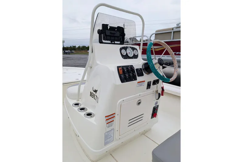 Slide: The Image of 2023 Mako 18 LTS boat console with steering wheel and control panel. - 8