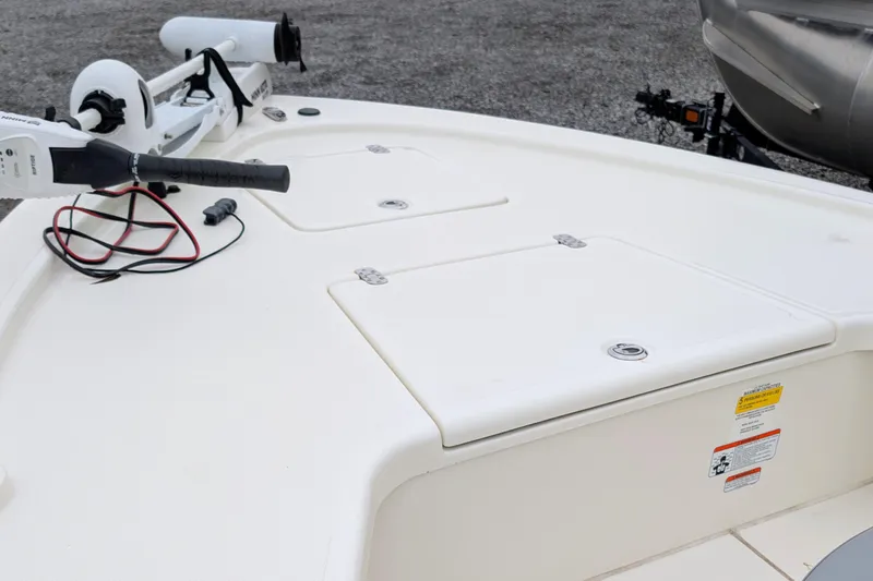 Slide: The Image of 2023 Mako 18 LTS boat deck with storage compartments and trolling motor. - 9