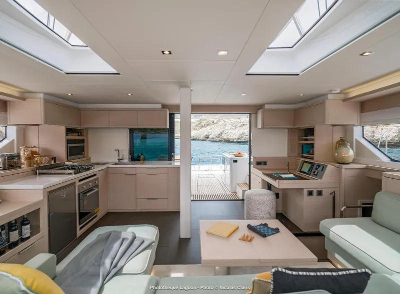 Slide: The Image of Luxurious interior of 2025 Lagoon 55 yacht with modern kitchen and scenic ocean view. - 15
