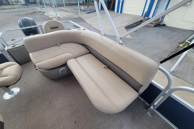 Slide: The Image of 2023 Sun Tracker Bass Buggy 18 DLX pontoon boat with beige seating and spacious deck. - 10