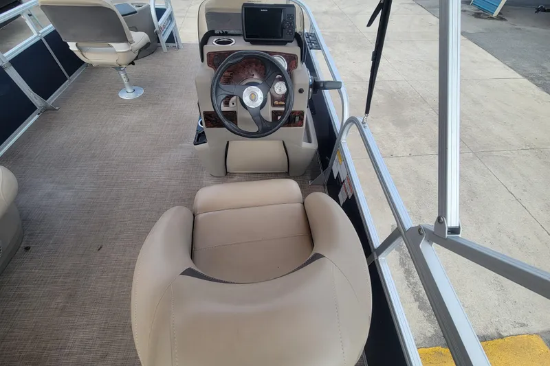 Slide: The Image of 2023 Sun Tracker Bass Buggy 18 DLX interior with steering wheel and seating. - 14