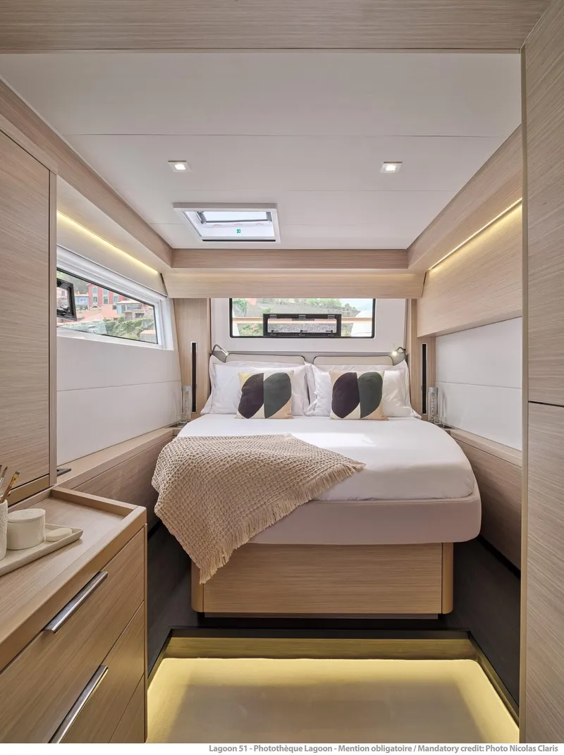 Slide: The Image of Luxurious interior of 2025 Lagoon 51 ICONIC yacht cabin with modern design and cozy bedding. - 47