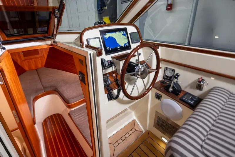 Slide: The Image of Interior of a 2008 San Juan 30 boat with navigation system and wooden accents. - 13