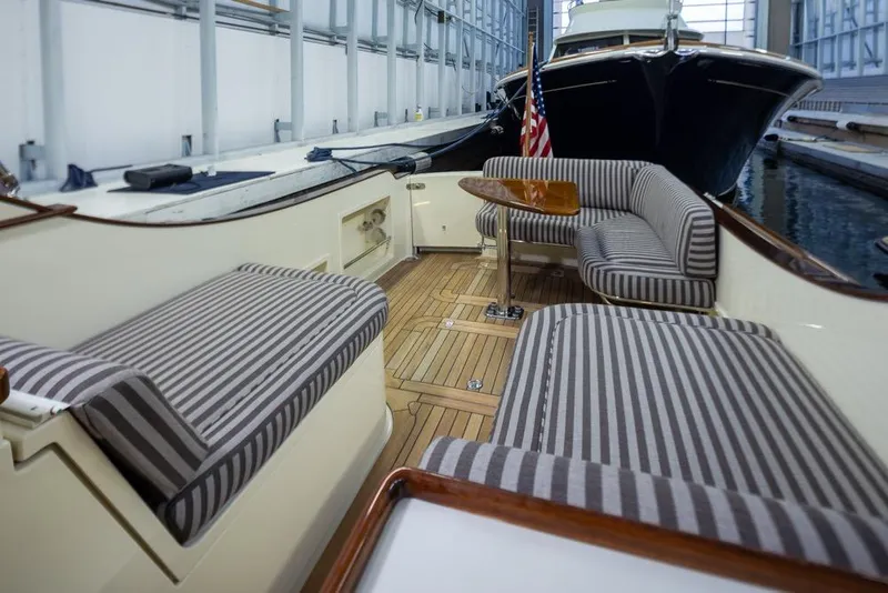 Slide: The Image of 2008 San Juan 30 boat interior with striped seating and wooden deck. - 15
