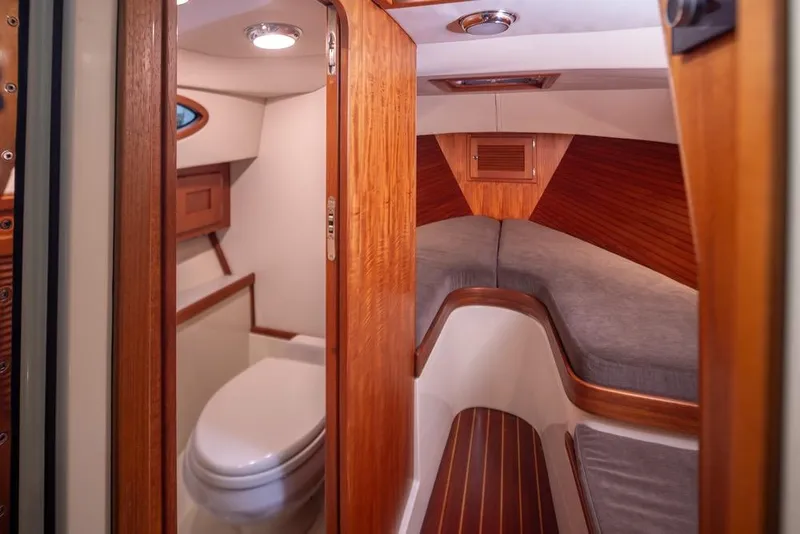 Slide: The Image of Interior of 2008 San Juan 30 boat, featuring cozy cabin and compact bathroom. - 17