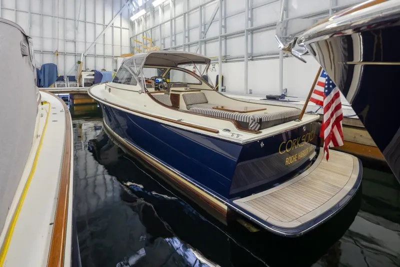 Slide: The Image of Luxury 2008 San Juan 30 yacht docked indoors with American flag. - 2