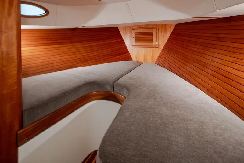 Slide: The Image of Interior cabin of 2008 San Juan 30 boat with wooden paneling and cozy bedding. - 21