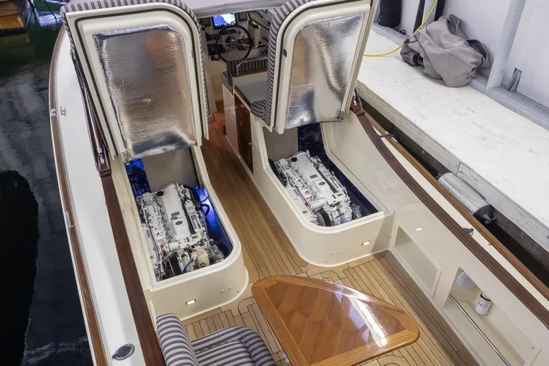 Slide: The Image of San Juan 30 yacht engine compartment, 2008 model, with open hatches and visible engines. - 25