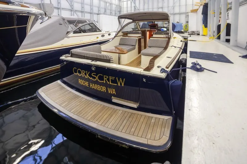 Slide: The Image of San Juan 30 boat, 2008 model, docked indoors with "Corkscrew" name visible. - 3