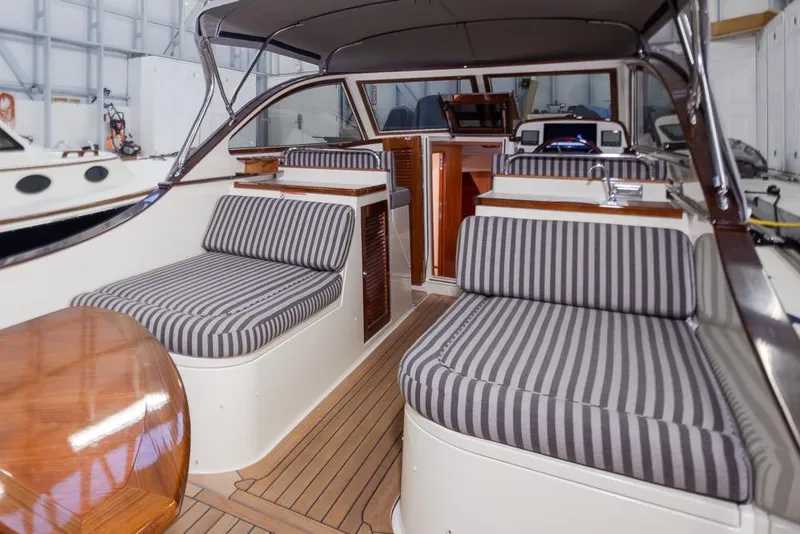 Slide: The Image of Interior of 2008 San Juan 30 boat with striped seating and wooden accents. - 8