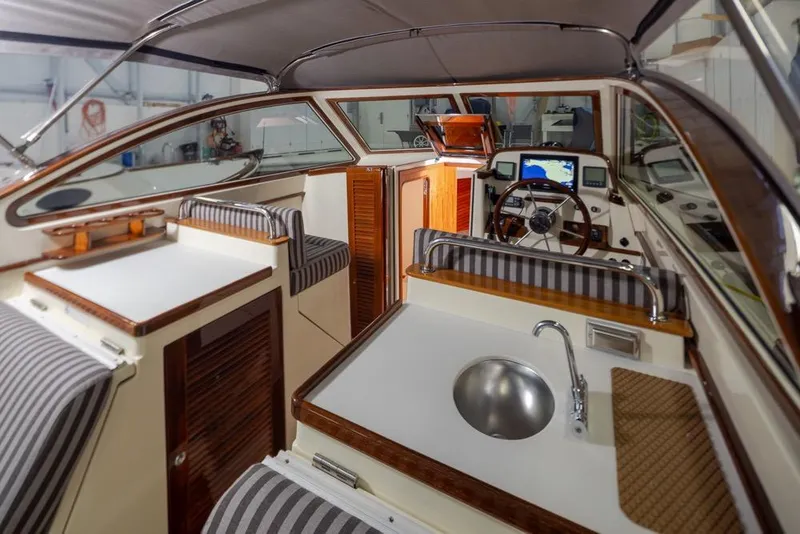 Slide: The Image of Interior of 2008 San Juan 30 boat with striped seating and modern helm. - 9