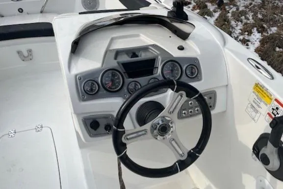 Slide: The Image of Steering console of a 2019 Tahoe 1950 boat with gauges and controls. - 5