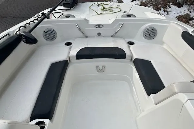 Slide: The Image of 2019 Tahoe 1950 boat interior with white and black seating, speakers, and storage compartments. - 6
