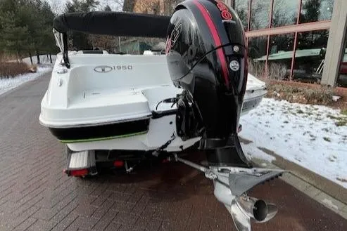 Slide: The Image of Tahoe 1950 boat, 2019 model, with an outboard motor, parked on a snowy driveway. - 7