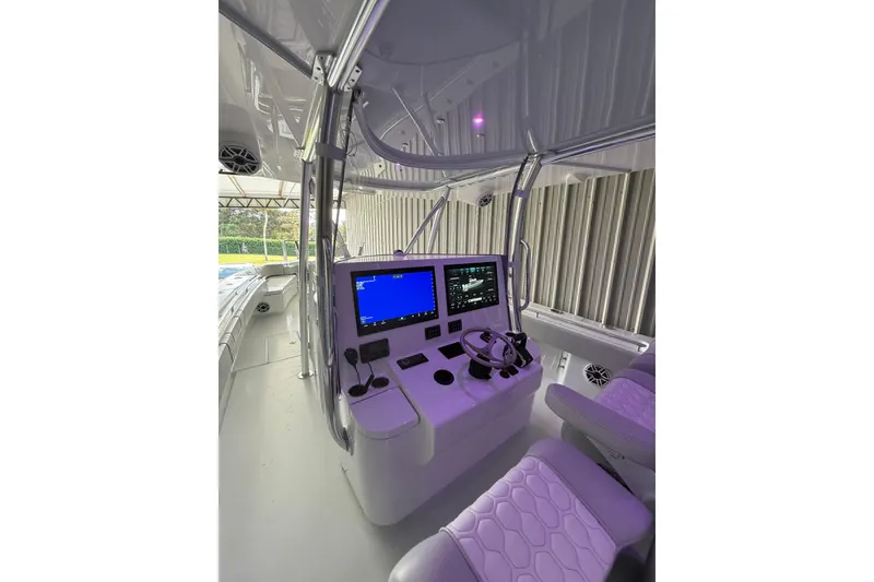 Slide: The Image of 2025 Contender 44 ST boat cockpit with advanced navigation system and modern seating. - 14