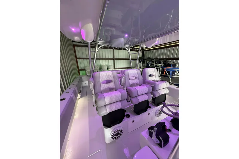 Slide: The Image of 2025 Contender 44 ST boat interior with luxurious seating and ambient lighting. - 15