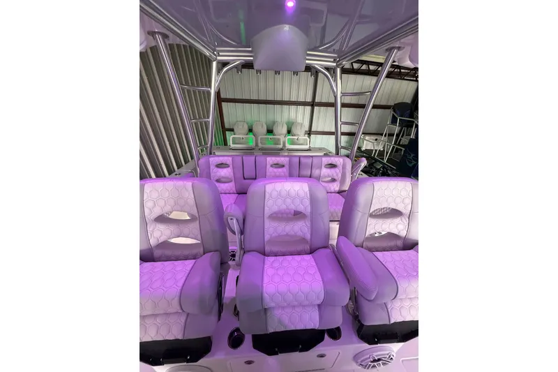 Slide: The Image of Interior of 2025 Contender 44 ST boat with purple-lit seating and modern design. - 16