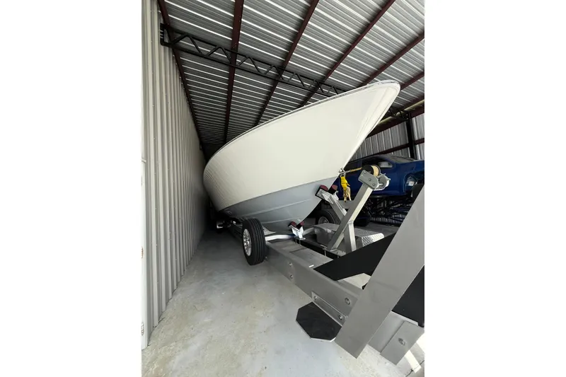 Slide: The Image of 2025 Contender 44 ST boat stored in a metal shed on a trailer. - 3
