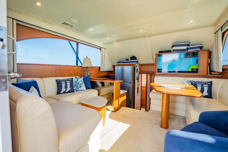 Slide: The Image of Luxurious yacht interior with plush seating, wooden accents, and modern amenities, Post 42 model, 2001. - 14