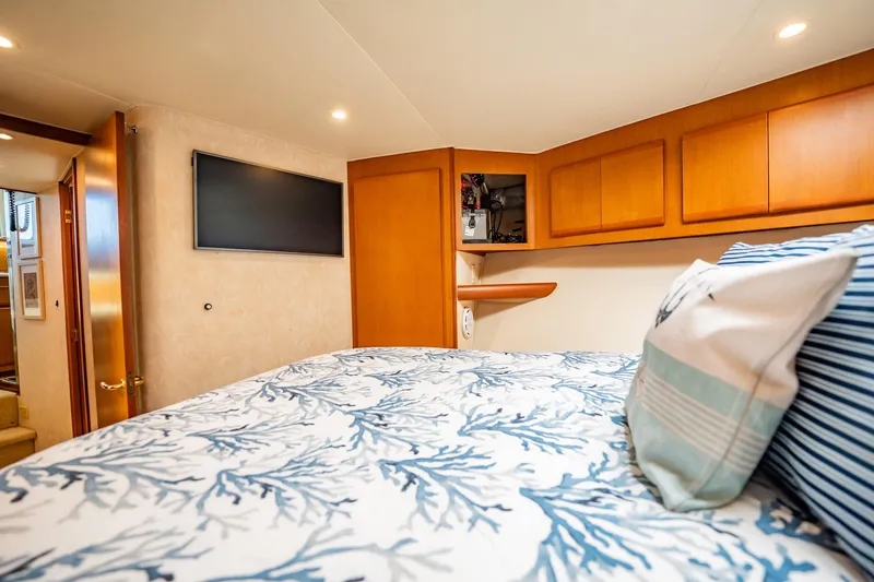 Slide: The Image of Luxurious cabin interior of 2001 Post 42 yacht with cozy bedding and modern amenities. - 25