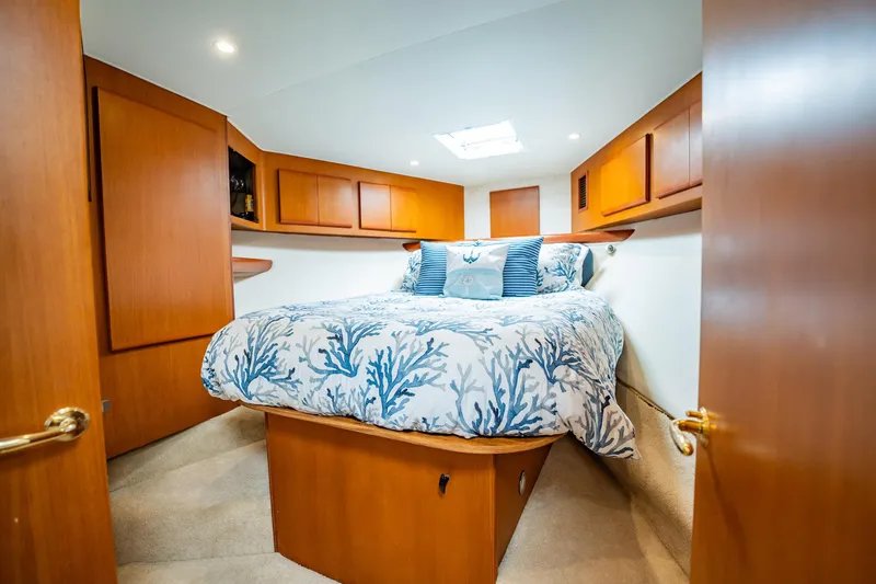 Slide: The Image of Luxurious cabin interior of 2001 Post 42 yacht with cozy bedding and wooden cabinetry. - 26