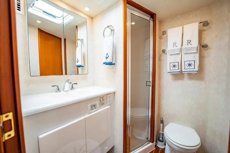 Slide: The Image of Luxurious yacht bathroom with modern fixtures, towels, and shower in a 2001 Post 42 model. - 30