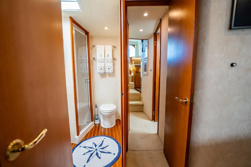Slide: The Image of Luxurious yacht bathroom with wooden doors, compass rug, and modern fixtures, Post 42 model, 2001. - 33