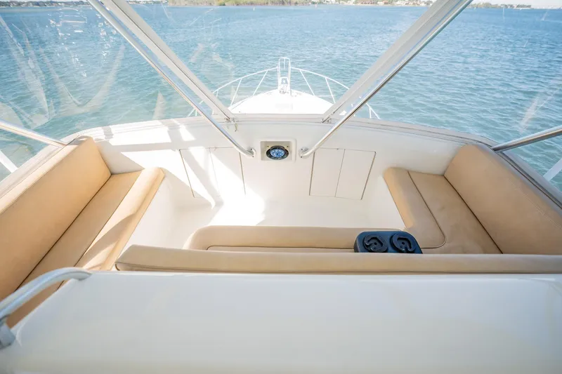 Slide: The Image of Interior view of a 2001 Post 42 boat with beige seating and ocean backdrop. - 43