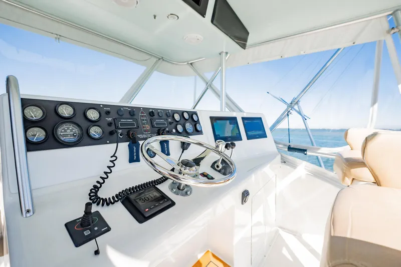 Slide: The Image of Helm of a 2001 Post 42 yacht with modern navigation instruments and steering wheel. - 45