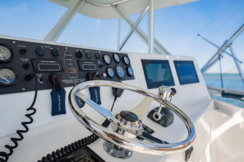 Slide: The Image of Helm of 2001 Post 42 boat with steering wheel and navigation controls. - 46