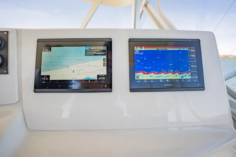 Slide: The Image of Dual Garmin marine displays on a 2001 Post 42 boat dashboard. - 47