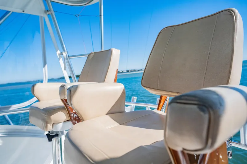 Slide: The Image of Luxury boat seating on a 2001 Post 42 model, overlooking serene blue waters. - 50