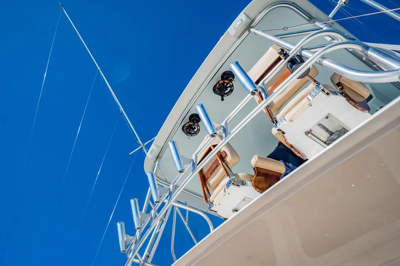 Slide: The Image of Luxury yacht deck with fishing rods against clear blue sky, Post 42 model, 2001. - 55
