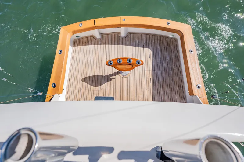 Slide: The Image of Aerial view of a 2001 Post 42 yacht's wooden deck and fishing chair on water. - 56