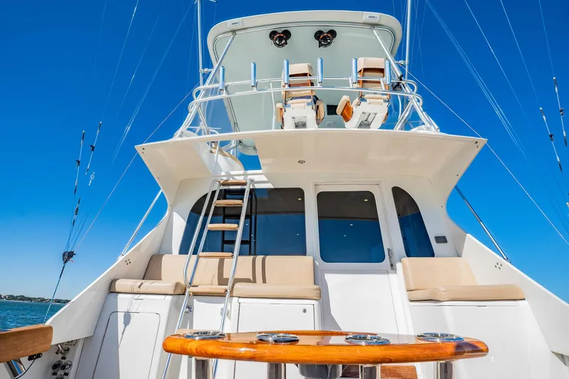 Slide: The Image of Luxury yacht deck with seating, ladder, and fishing rods under clear blue sky. Post 42, 2001 model. - 59