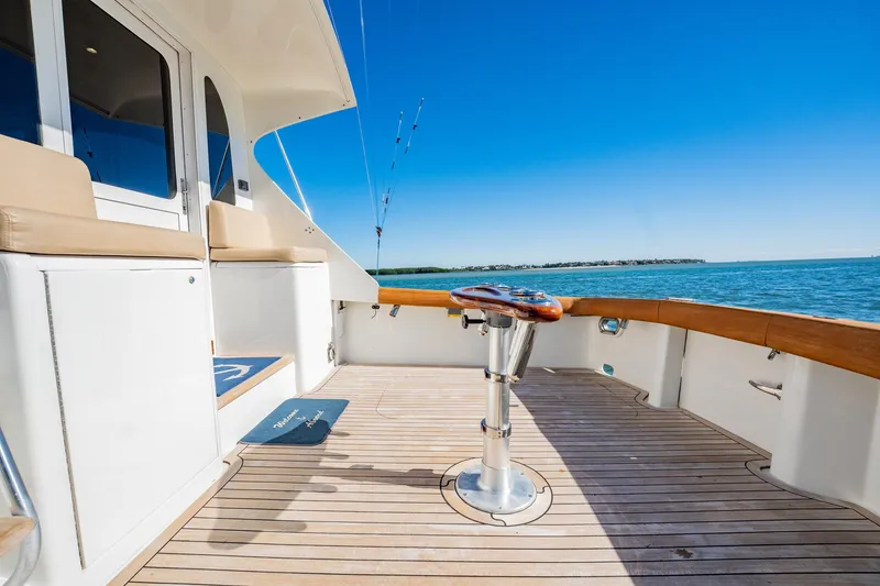 Slide: The Image of Luxury yacht deck with fishing chair, ocean view, clear blue sky, Post 42 model, 2001. - 65