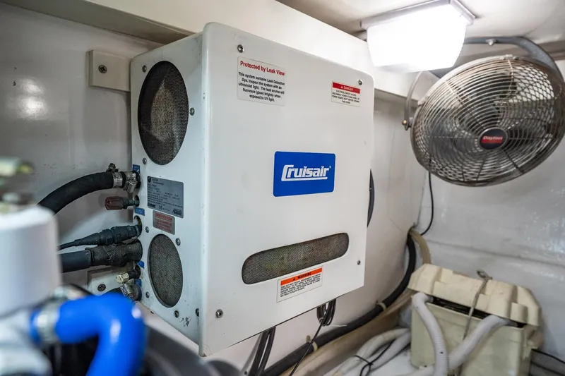 Slide: The Image of Cruisair unit in a 2001 Post 42 model, with visible fan and hoses. - 70