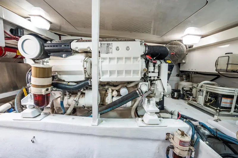Slide: The Image of Engine room of a 2001 Post 42 boat, featuring a well-maintained marine engine. - 72