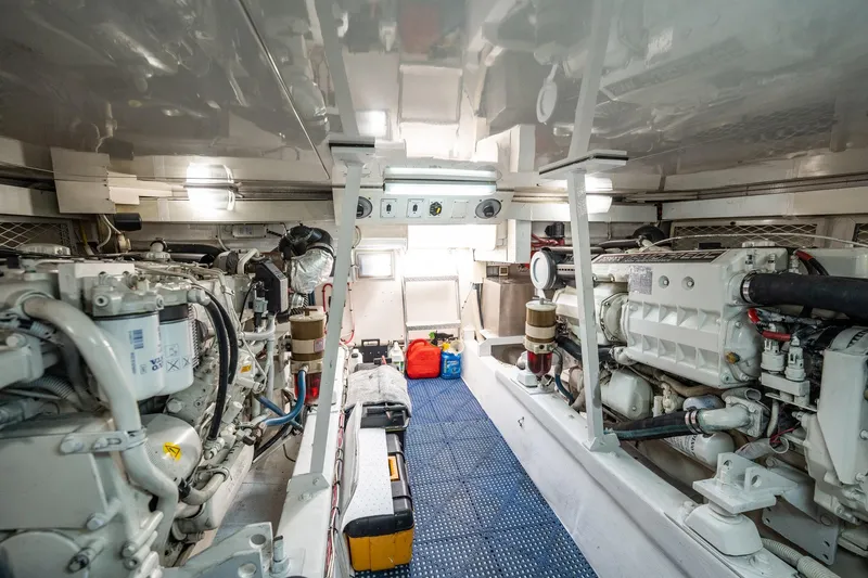 Slide: The Image of Engine room of a 2001 Post 42 boat, featuring dual engines and organized layout. - 74