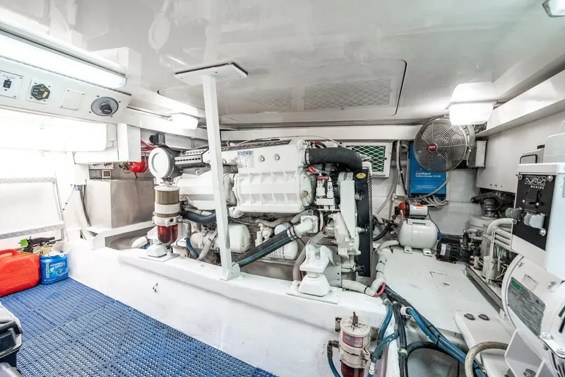 Slide: The Image of Engine room of a 2001 Post 42 boat, featuring machinery and equipment. - 75