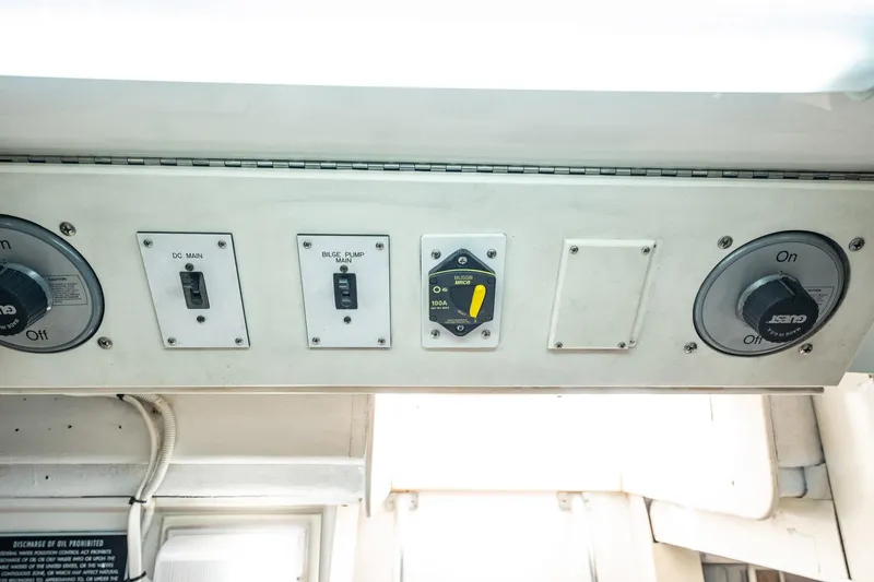 Slide: The Image of Control panel with switches and dials on a 2001 Post 42 model boat. - 76