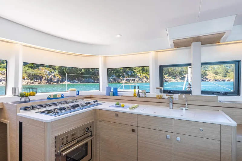 Slide: The Image of Modern kitchen interior of 2025 Lagoon 43 yacht with scenic ocean view. - 18