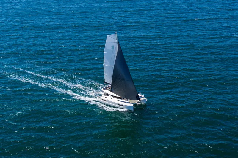 Slide: The Image of Sailing Lagoon 43 catamaran, 2025 model, gliding on open blue sea. - 2