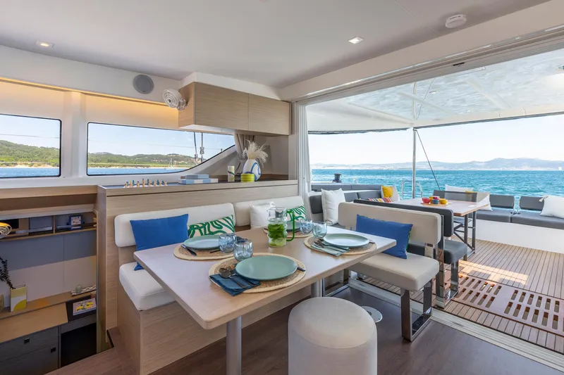 Slide: The Image of Luxurious interior of 2025 Lagoon 43 yacht with ocean view and elegant dining setup. - 21