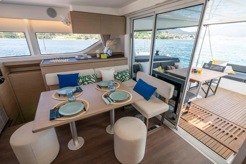 Slide: The Image of Luxurious interior of 2025 Lagoon 43 yacht with elegant dining area and scenic ocean view. - 23